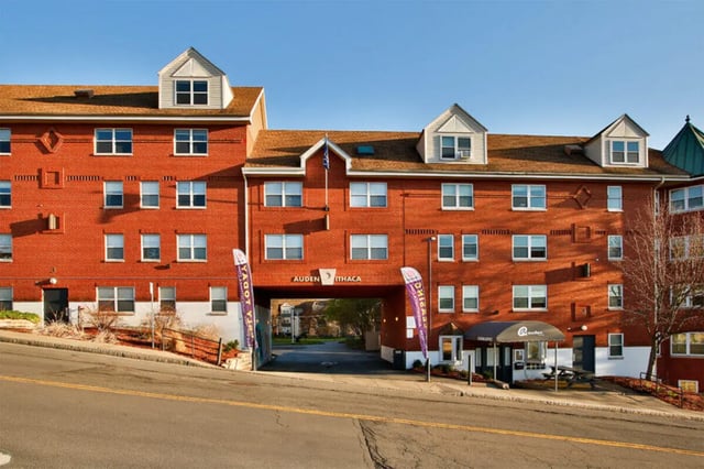 Brick apartment building with archway and signage exterior at Auden Ithaca in Ithaca Student Accommodation