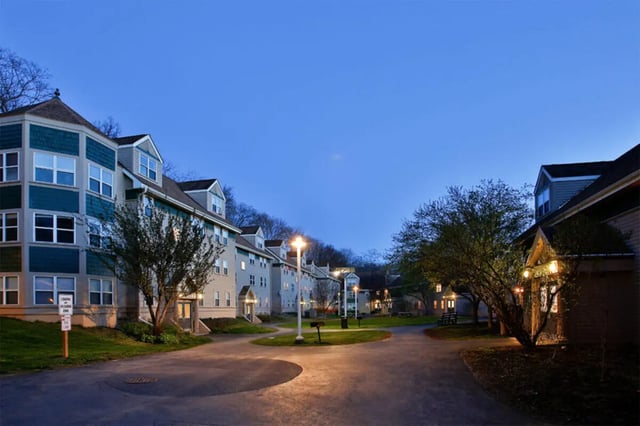 Apartment buildings and trees at dusk exterior at Auden Ithaca in Ithaca Student Accommodation