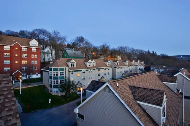 Apartment buildings with grass courtyard exterior at Auden Ithaca in Ithaca Student Accommodation
