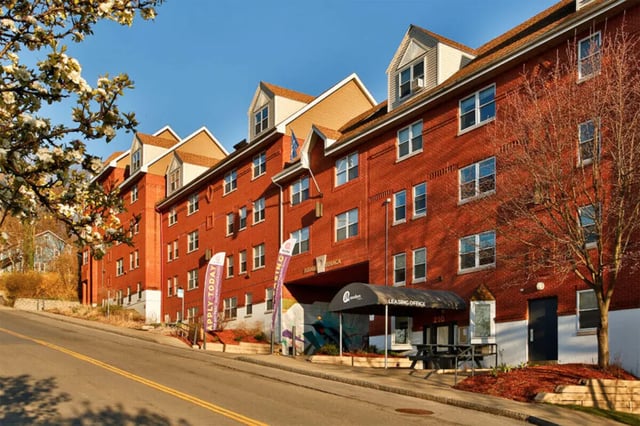 Brick student building with leasing office exterior at Auden Ithaca in Ithaca Student Accommodation