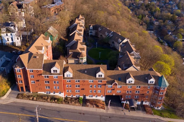 Brick buildings with many windows exterior at Auden Ithaca in Ithaca Student Accommodation