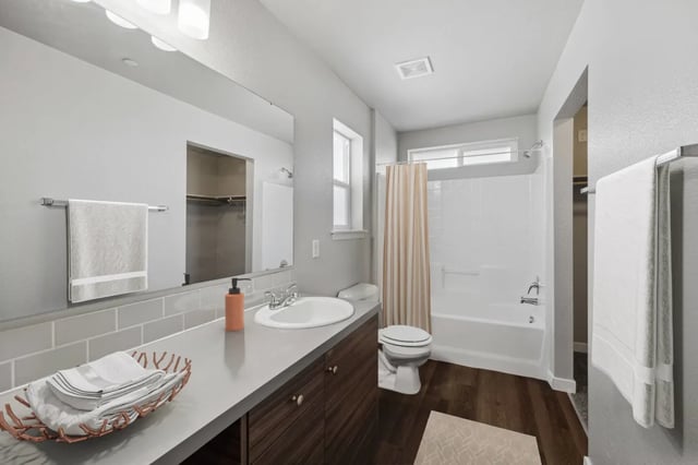 Sink toilet bathtub shower with curtain bathroom at Ridgecrest Commons in Nampa Student Accommodation