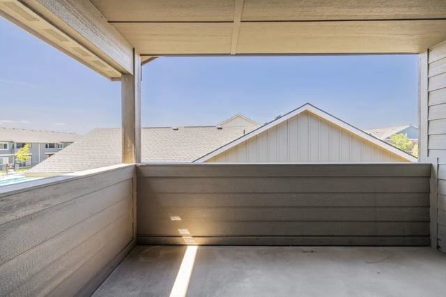 Balcony with view of apartment buildings and pool exterior at Ridgecrest Commons in Nampa Student Accommodation