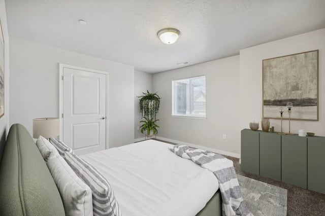 Bed pillows artwork green cabinet bedroom at Ridgecrest Commons in Nampa Student Accommodation
