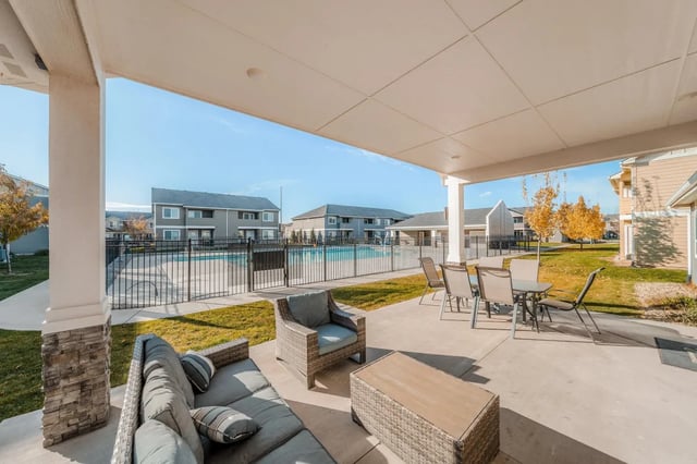 Sofa chairs table and pool exterior at Ridgecrest Commons in Nampa Student Accommodation