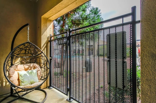 Hanging chair with cushions on balcony balcony exterior at The Crimson in Tuscaloosa Student Accommodation