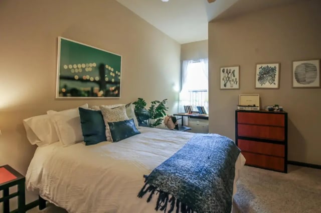 Bed with pillows artwork and dresser Bedroom at The Crimson in Tuscaloosa Student Accommodation
