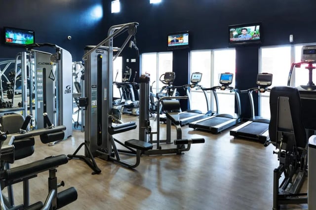 Workout machines treadmills TVs gym gym at The Crimson in Tuscaloosa Student Accommodation