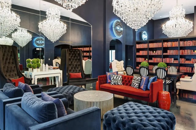 Velvet sofas chandeliers ornate chairs library living room at The Crimson in Tuscaloosa Student Accommodation