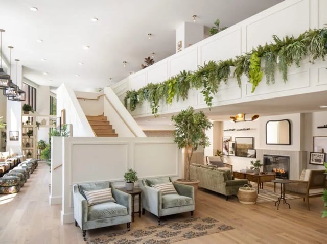 Seating area staircase plants fireplace living room at Rambler Athens in Atlanta Student Accommodation