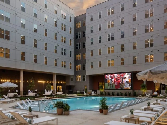 Courtyard with pool outdoor seating and large screen exterior at Rambler Athens in Atlanta Student Accommodation