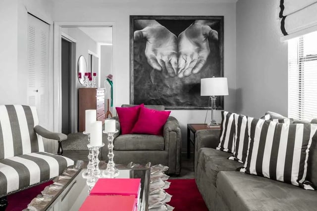 Striped chairs art large hands painting living room at The London in College Station Student Accommodation