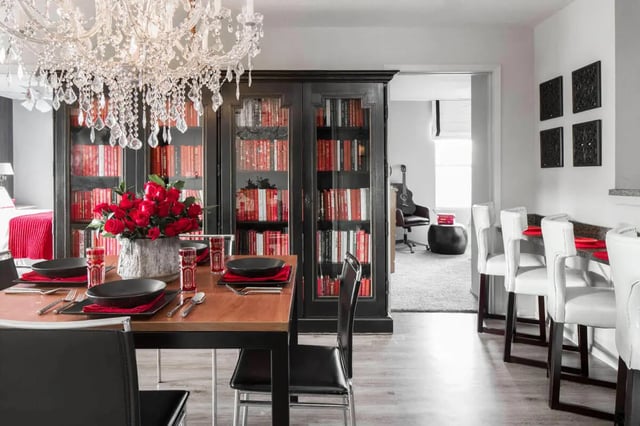 Dining table red roses chandelier bar stools dining area at The London in College Station Student Accommodation