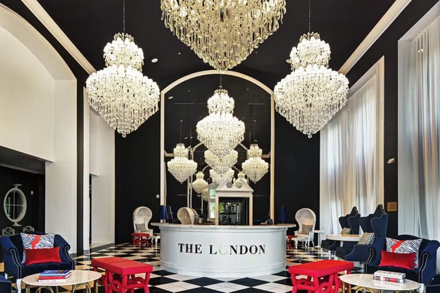 Lobby with chandeliers seating and reception desk lobby at The London in College Station Student Accommodation