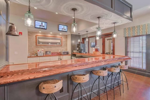 Wooden bar stools and counter with pendant lights communal area at The Reserve in Carrollton Student Accommodation