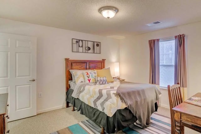 Bed desk and pillows bedroom at The Reserve in Carrollton Student Accommodation