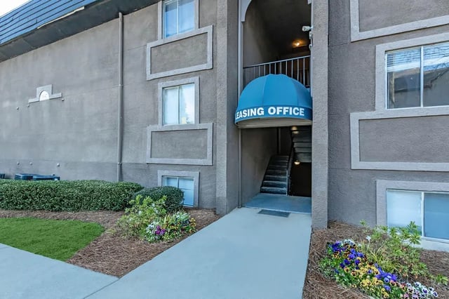 Blue awning stairs leasing office exterior at Villas De Las Colinas 1 in Atlanta Student Accommodation