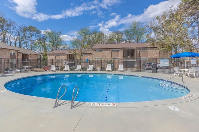 Pool with lounge chairs and buildings exterior at Villas De Las Colinas 2 in Atlanta Student Accommodation