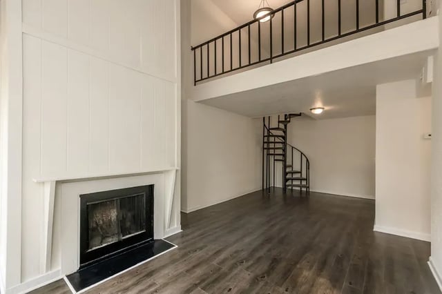 Fireplace spiral staircase loft balcony living room at Villas De Las Colinas 4 in Atlanta Student Accommodation