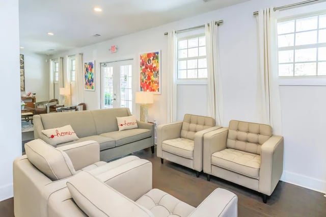 Sofa chairs with patterned art and windows living room at Villas De Solana in Atlanta Student Accommodation