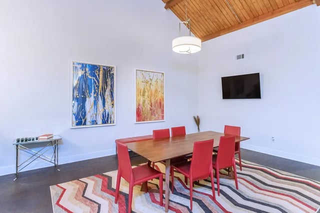 Wooden table red chairs modern art living room at Villas De Solana in Atlanta Student Accommodation