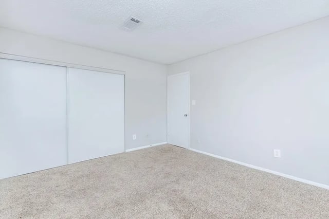 Closet doors white door carpeted floor bedroom at Villas Del Mirasol in Roswell Student Accommodation