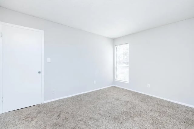 Empty room with carpet white door window Bedroom at Villas Del Mirasol in Roswell Student Accommodation