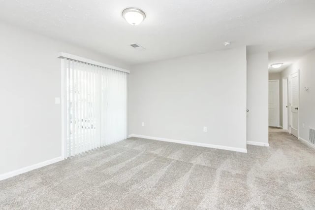 Empty room with carpet and sliding doors Living room at Villas Del Mirasol in Roswell Student Accommodation