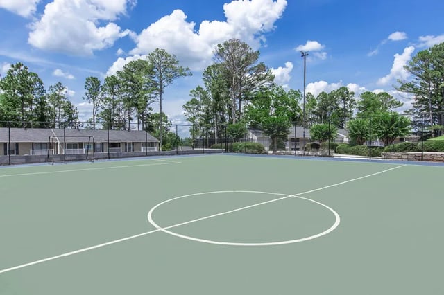 Sports court with soccer goal and buildings playing area at Villas Del Mirasol in Roswell Student Accommodation