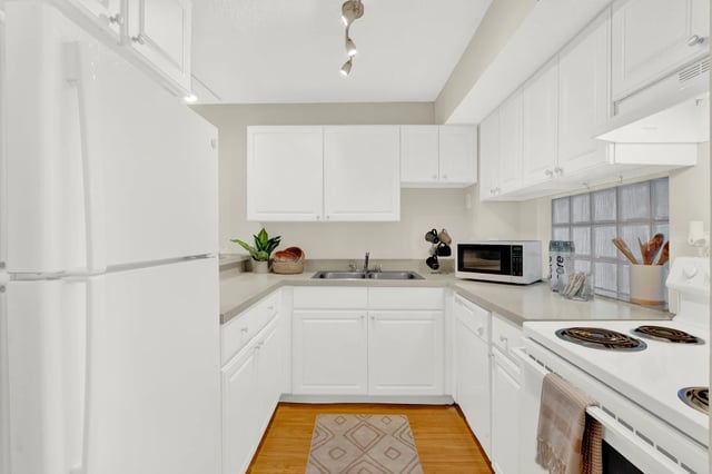 White refrigerator microwave cabinets sink kitchen at on50 Tampa Apartments in Tampa Student Accommodation