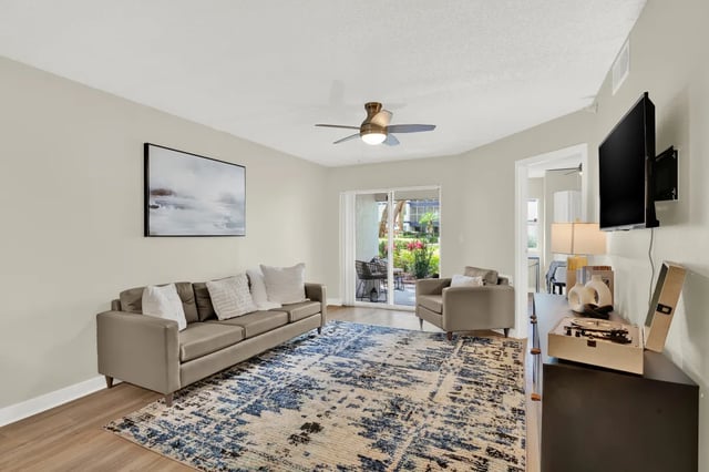 Sofa armchair artwork ceiling fan living room at on50 Tampa Apartments in Tampa Student Accommodation