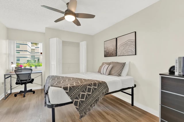 Bed desk chair artwork closet bedroom at on50 Tampa Apartments in Tampa Student Accommodation