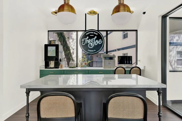 Coffee machine printer computers chairs The Joe coffee bar living area at on50 Tampa Apartments in Tampa Student Accommodation