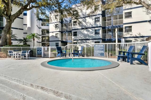 Blue Adirondack chairs surround a spa exterior at on50 Tampa Apartments in Tampa Student Accommodation