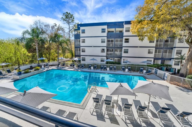 Pool with lounge chairs and umbrellas exterior at on50 Tampa Apartments in Tampa Student Accommodation