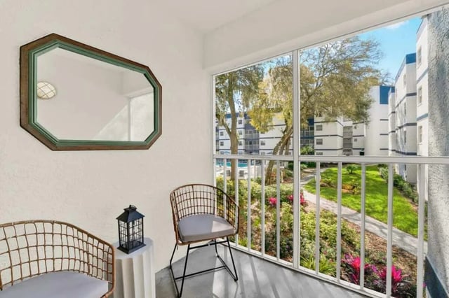 Two chairs mirror and lantern balcony at on50 Tampa Apartments in Tampa Student Accommodation