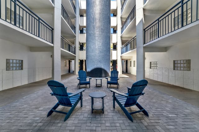 Blue chairs and tables courtyard exterior at on50 Tampa Apartments in Tampa Student Accommodation