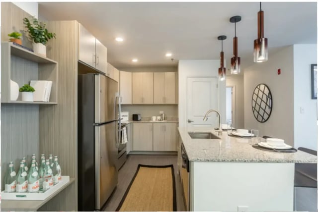 Modern kitchen with stainless steel appliances and island kitchen at Altitude Apartments Harrisonburg in Harrisonburg Student Accommodation