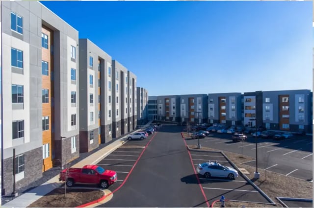 Modern apartment buildings with parking lot exterior at Altitude Apartments Harrisonburg in Harrisonburg Student Accommodation