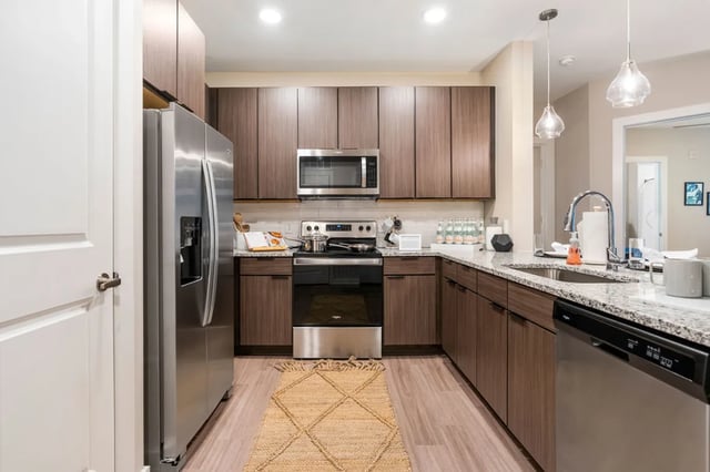 Stainless steel refrigerator stove microwave and dishwasher kitchen at The Indy Apartments in Marietta Student Accommodation