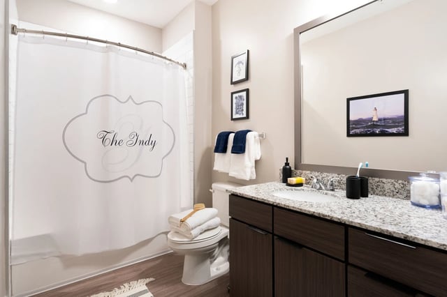 Shower curtain toilet towels sink vanity mirror bathroom at The Indy Apartments in Marietta Student Accommodation