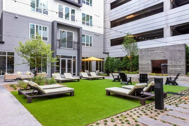 Lounge chairs on green lawn outdoor communal area at The Indy Apartments in Marietta Student Accommodation