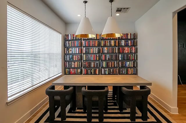 Bookshelves with table and chairs study area at The Leonard Denton in Denton Student Accommodation
