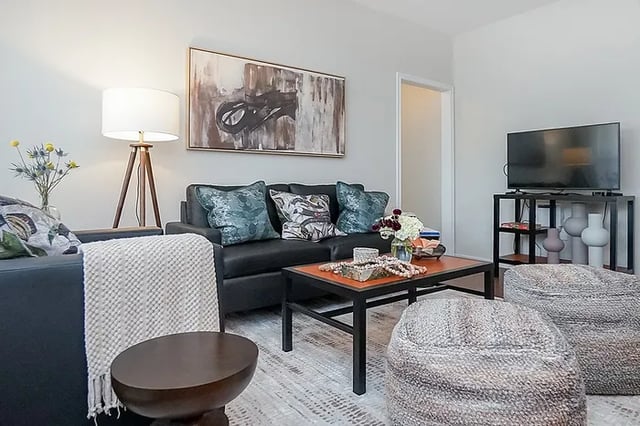 Black couch coffee table bean bags living room at The Leonard Denton in Denton Student Accommodation