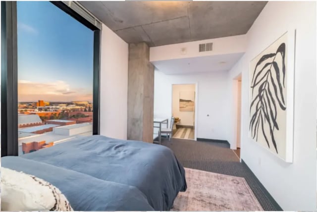Bed with city view art and dining area Bedroom at The Pacific and Malibu in Tucson Student Accommodation
