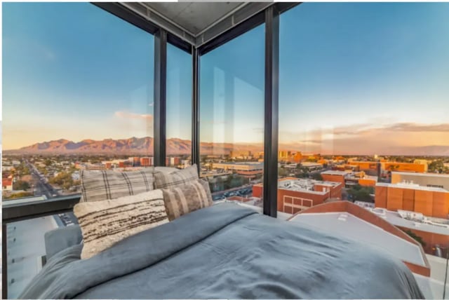Bed with pillows and city view Bedroom at The Pacific and Malibu in Tucson Student Accommodation