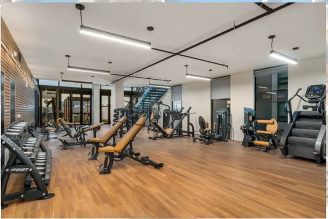 Dumbbells benches stair climber gym equipment fitness area at The Pacific and Malibu in Tucson Student Accommodation