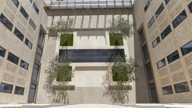 Courtyard with trees grass and water feature exterior at Victoria Hall Kings Cross in London Student Accommodation