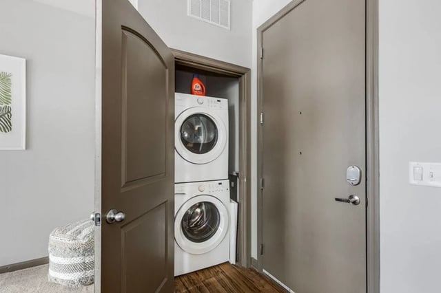 Stacked washer and dryer with laundry detergent Laundry area at The James Apartments Richmond in Richmond Student Accommodation