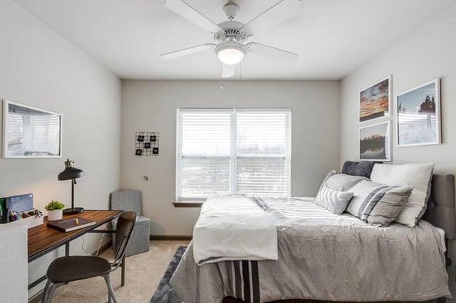 Bed desk lamp chair framed art bedroom at The James Apartments Richmond in Richmond Student Accommodation